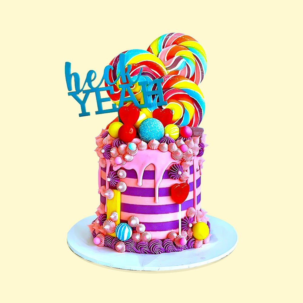 Zoi&Co Heck YEAH Cake Topper on striped candy cake