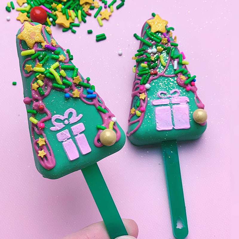 christmas trees shaped cakesicles showing the green candy forest mini cakesicle sticks zoiandco
