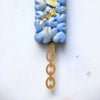 blue cakesicle showing the gold round & chained mini cakesicle stick zoiandco