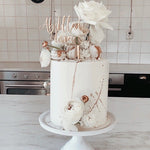 wedding cake topper in metallic gold with wedding cake